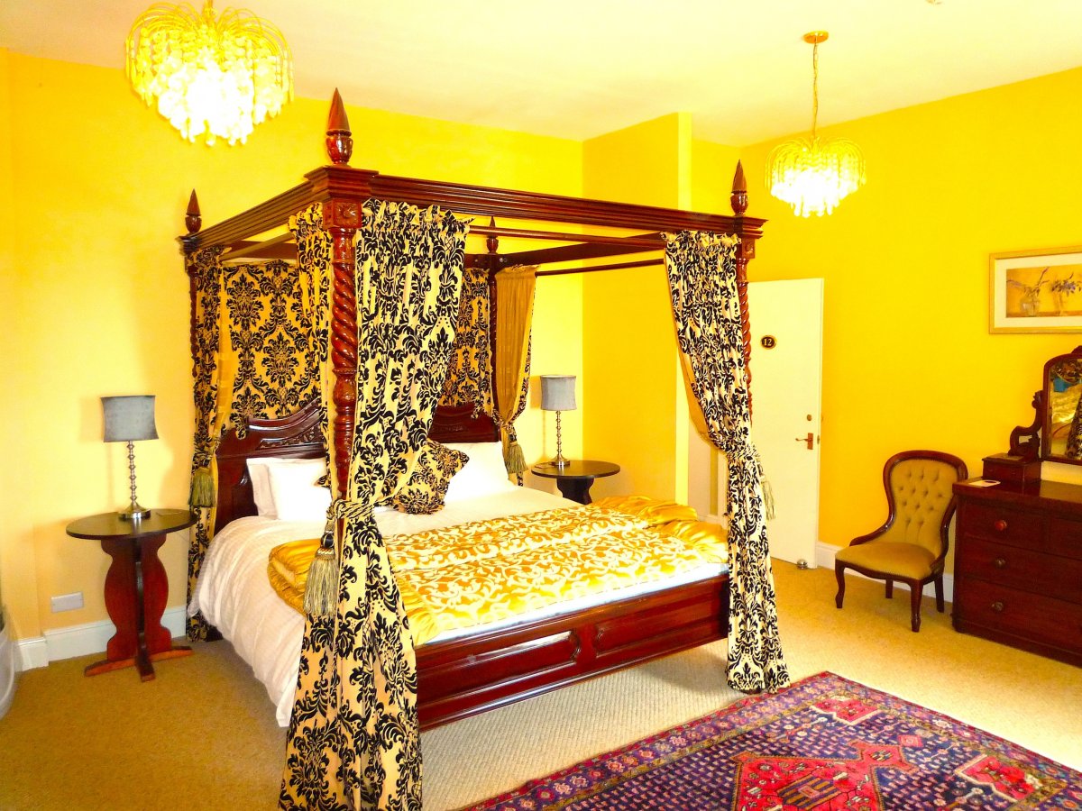 Master bedroom with regal super king four poster bed
